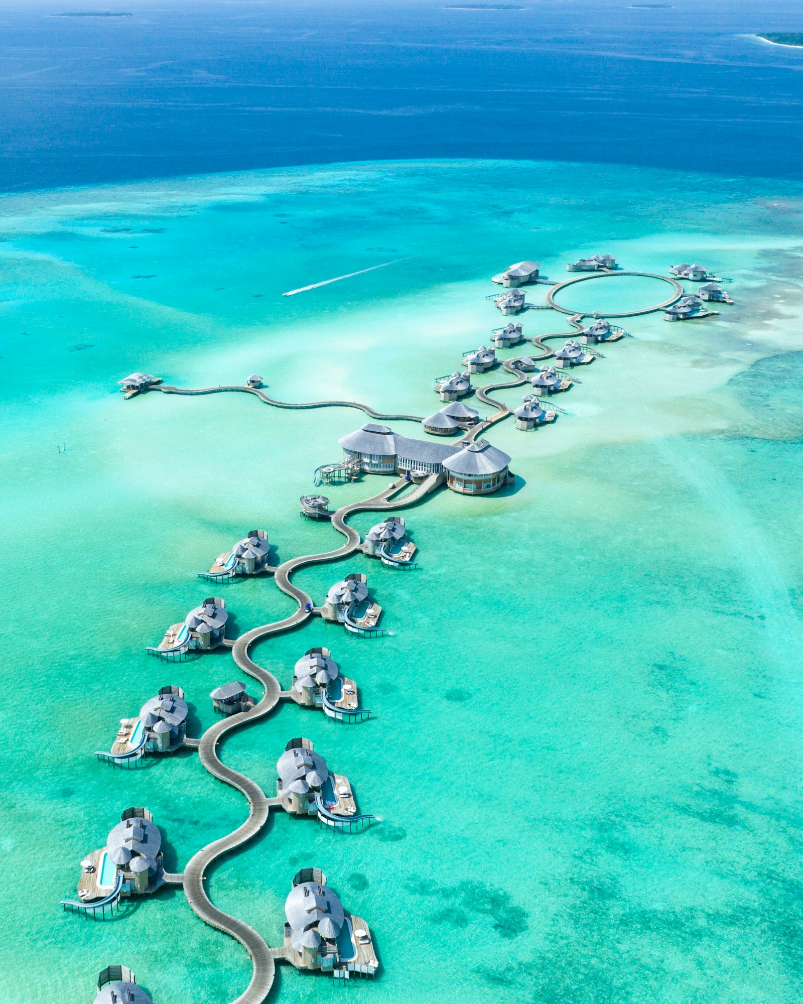 Overwater bungalows in the Maldives — compared against Dubai beach clubs