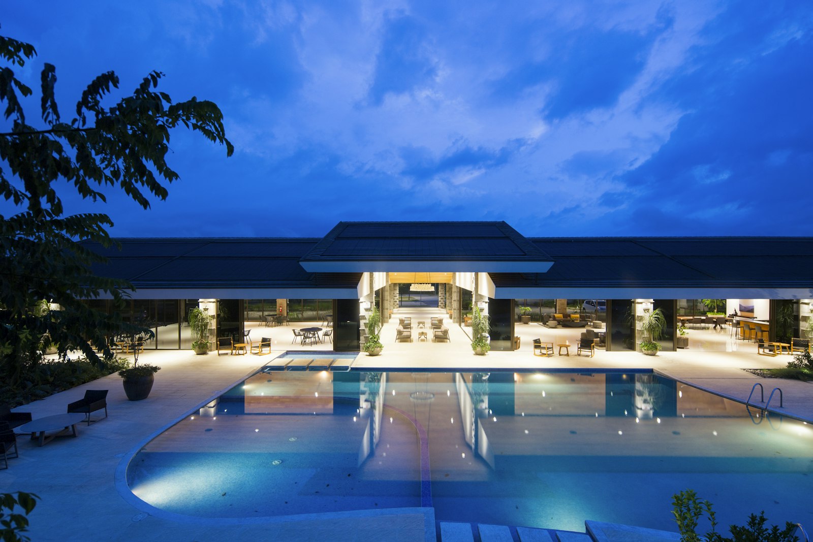 Dubai beach club pool in warm summer light with sun loungers