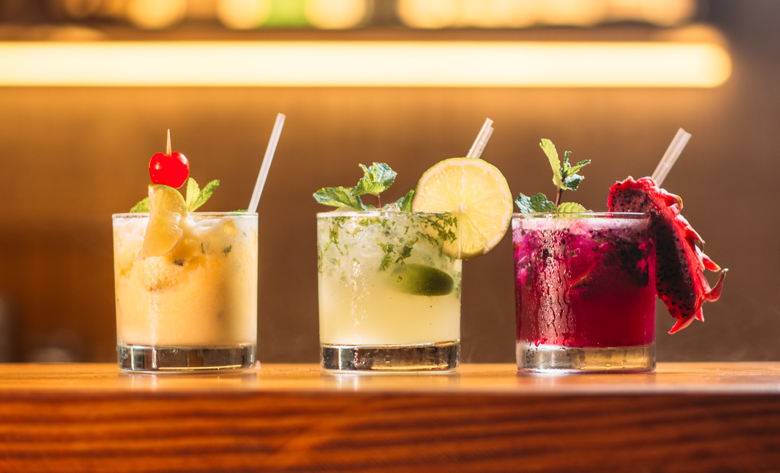 Colourful signature cocktails served at a Dubai beach club bar with sea view