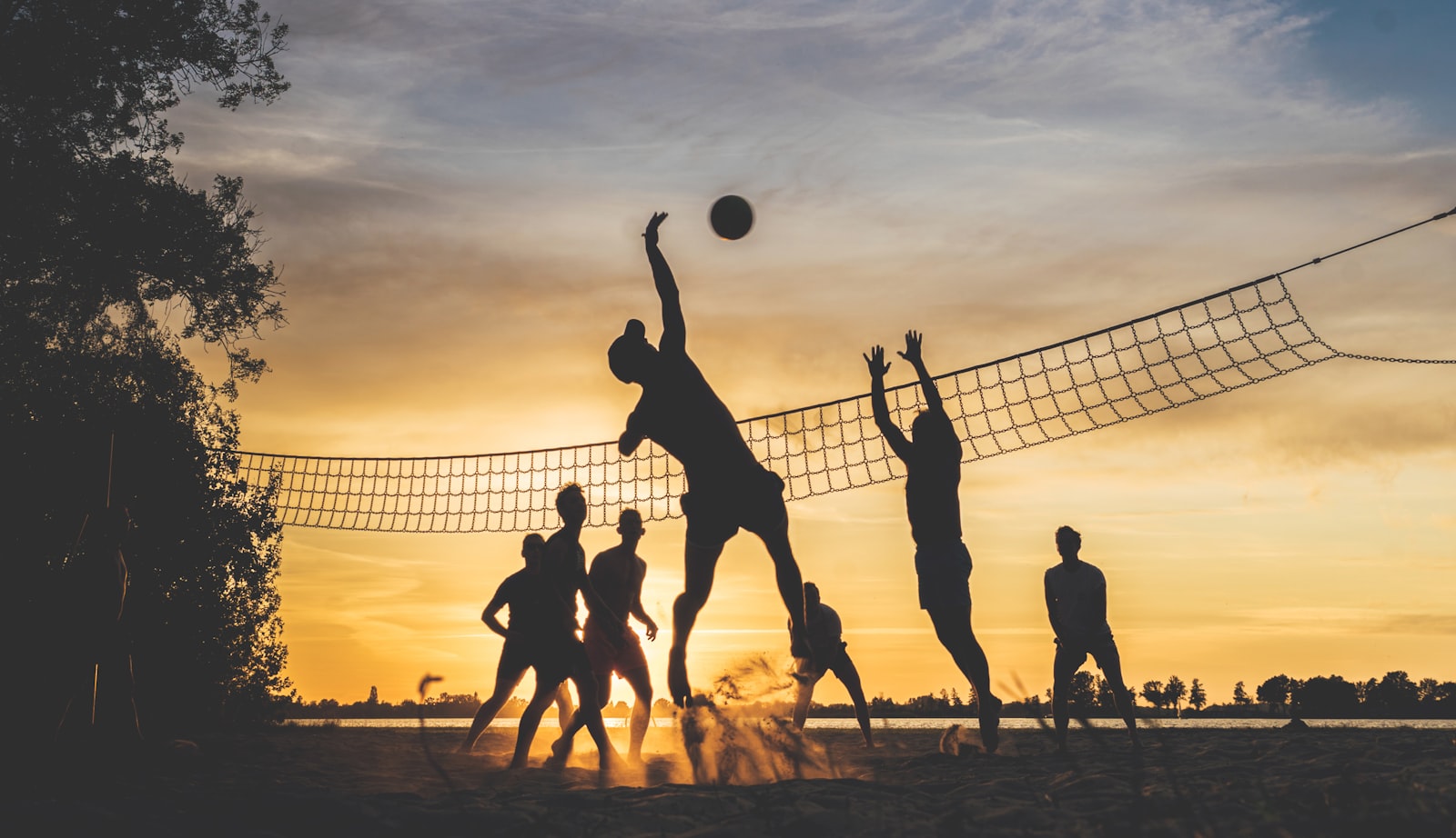 Beach volleyball players on a Dubai beach with clear blue sea in the background