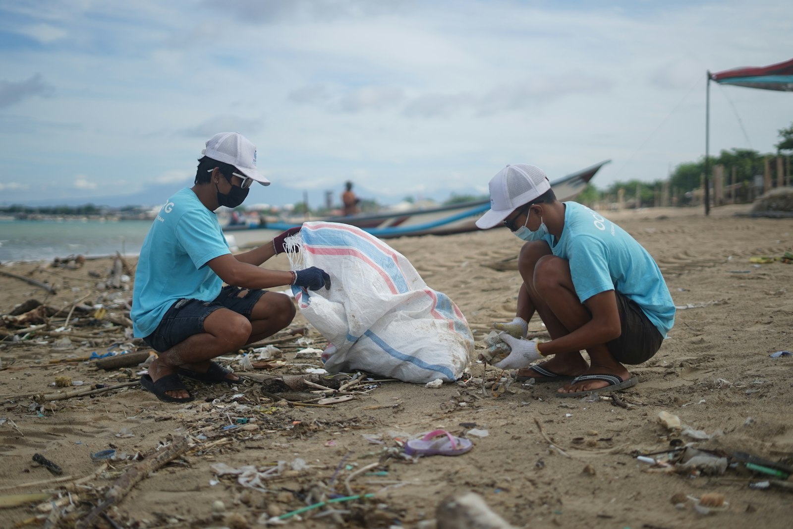Volunteers collecting plastic waste during a beach cleanup event on a Dubai beach