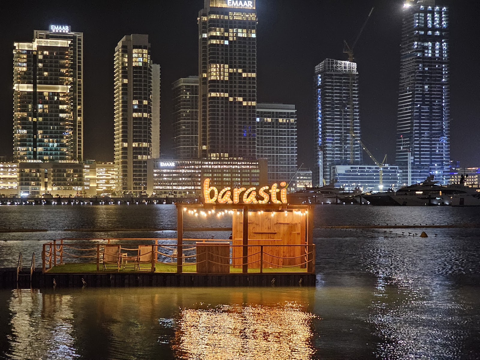 Dubai beach club pool area with water sports equipment and sunbeds
