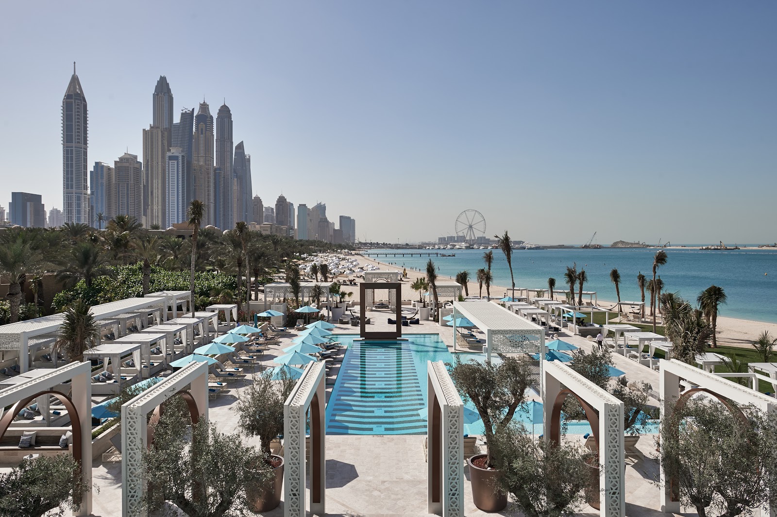 Family enjoying a beach day in Dubai with children playing in the water