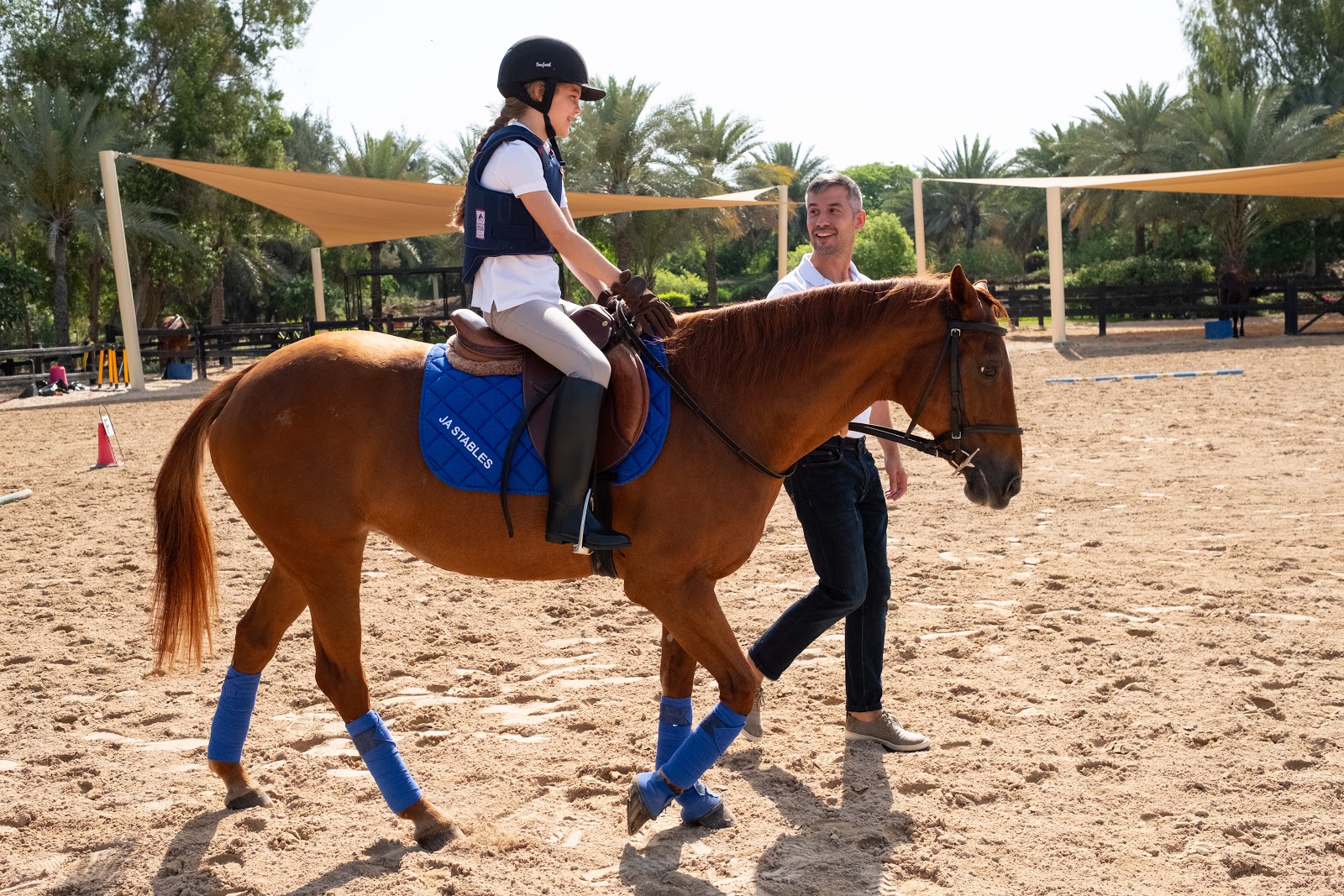 Family-friendly beach Dubai with children playing in shallow waters on a sunny beach day