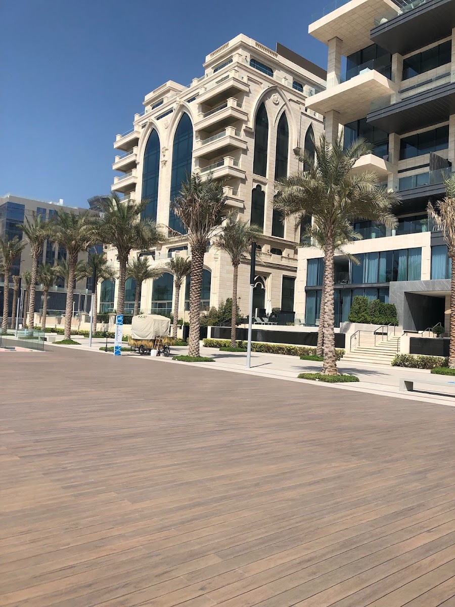 JBR beach Dubai with The Walk promenade in the foreground — accessible on foot from Dubai Marina Tram