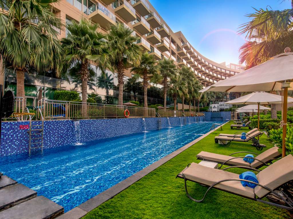 Rixos Palm Dubai — luxury all-inclusive beach resort with pools and loungers on Palm Jumeirah