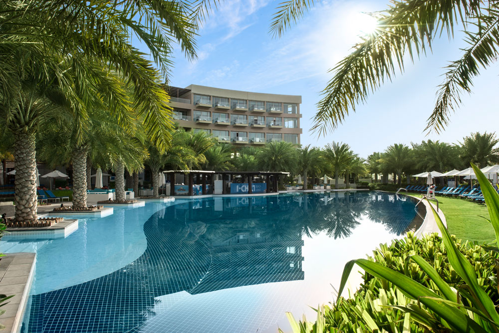 Budget-friendly outdoor swimming pool with sun loungers in Dubai